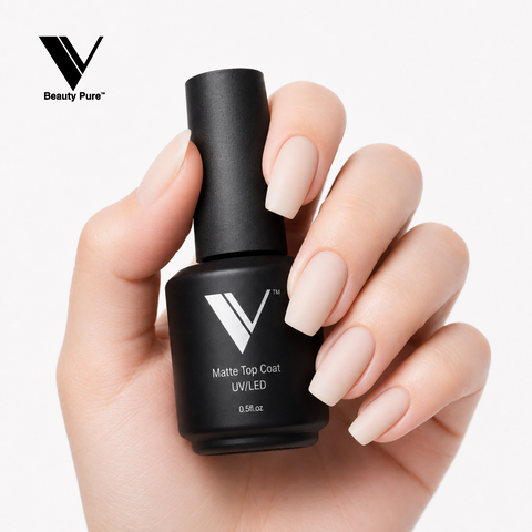 A hand with long, matte nude nails holds a V Beauty Pure Non Wipe Matte Top Coat for a flawless gel manicure finish.