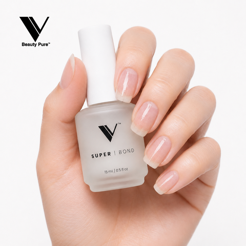 A manicured hand holds V Beauty Pure - Super Bond - Primer for maximum adhesion; white background.
