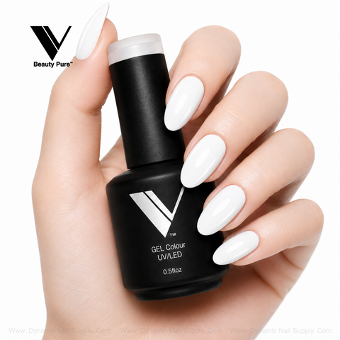 A hand with long, white nails holds a V Beauty Pure - Super White Gel Polish 045 bottle against a white background.