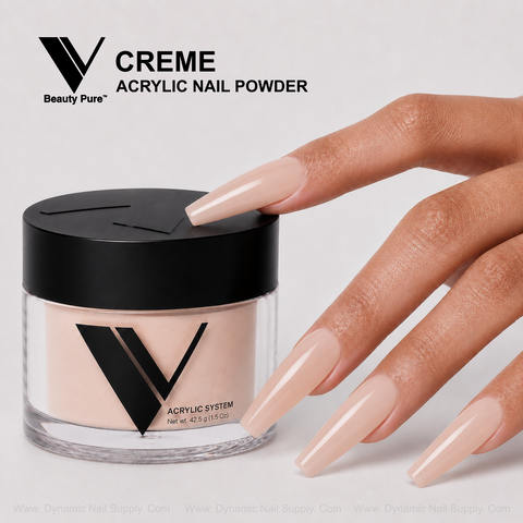 A hand with long, nude acrylics holds a jar labeled V Beauty Pure - Creme Acrylic Powder for salon-perfect nails.