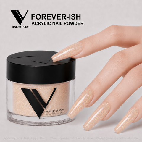 A hand with long, glittery nude nails touches a jar of V Beauty Pure - Forever-ish Acrylic Powder for salon nails.