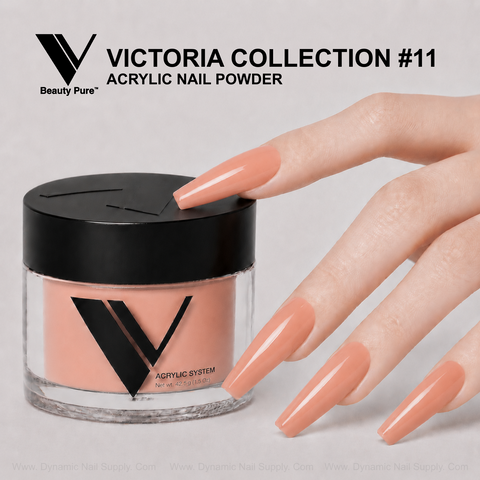 A hand with long peach nails holds V Beauty Pure - Victoria Collection #11 Acrylic Powder, ideal for creative nail art.