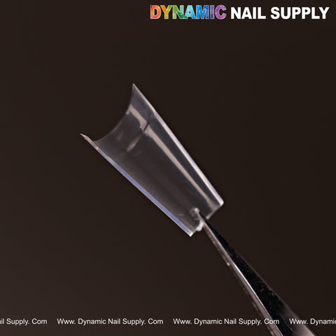 A clear New Short Coffin Nail Tip is held by tweezers, with Dynamic Nail Supply text above on a dark background.