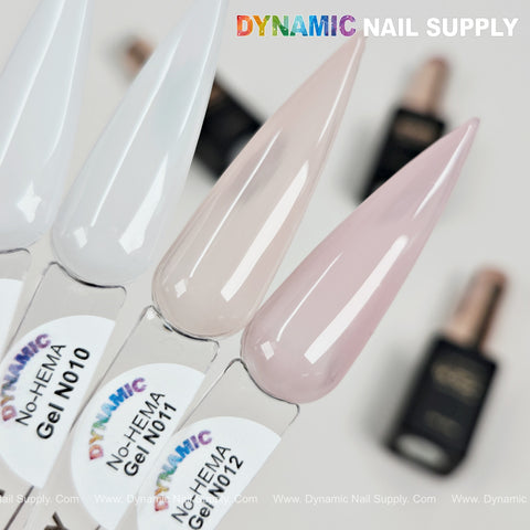 Three swatches—white, nude neutral, and pink—with DYNAMIC No-HEMA Nude Neutral Gel Polish bottles in the back.
