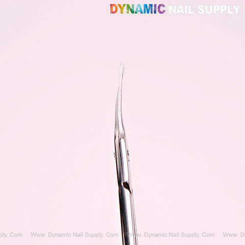 Close-up of NT1215 Silver Premium Curved Tip Cuticle Scissors, stainless steel, on a pale background with branding.