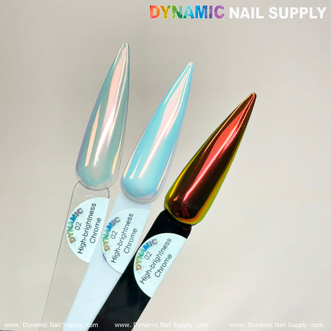 Three nail polish swatches from Dynamic Nail Supply beautifully display a range of colors: the left features a shimmery pearl, the middle is adorned with a glossy light blue, and the right boasts a metallic red with a gold shift. These samples, labeled Golden/Light-Orange Iridescent Chrome #02 - High brightness Fine Pigment Powder, are ideal for any nail art design enthusiast.