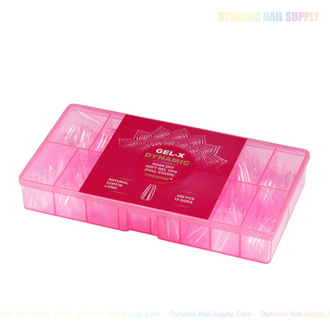 A pink box with dividers holds Natural Coffin (Long) Full Cover Soft-Gel Nail Tips and a red GEL-X DYNAMIC label.