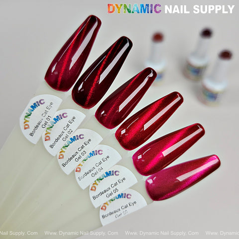 Six swatches of Bordeaux Cat Eye #1 magnetic glassy red wine shimmery gel polish, fanned on white.
