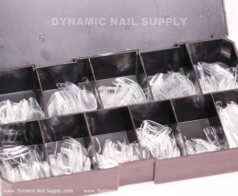An organizer box from Dynamic Nail Supply contains a set of [Round M] Full Cover Tips - Soft Gel X tips, made of black plastic with clear compartments. The box, which is open to reveal the neatly arranged soft gel tips in sizes numbered 0 through 9, holds a total of 600 medium long pieces ideal for creating flawless press-on nails.