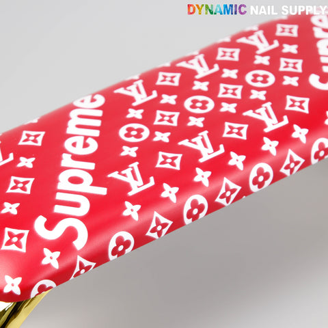 A red [R-A043] 5upreme Pattern handrest armrest for manicure/pedicure under a DYNAMIC NAIL SUPPLY sign.