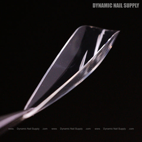A close-up of Sculpted Stiletto XL Full Cover Soft-Gel Nail Tips (Black Box) against a black background.