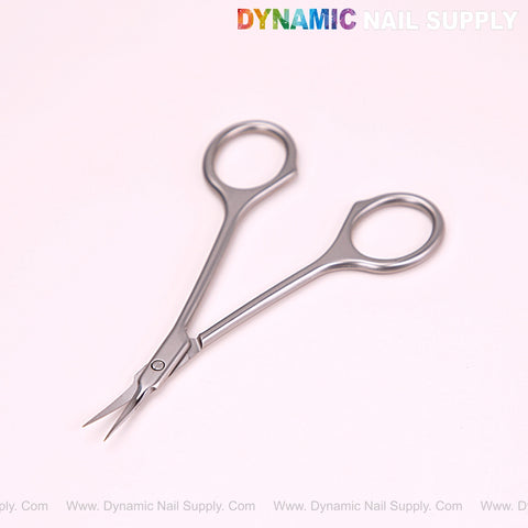 NT1246 Silver Premium Curved Tip Cuticle Scissors on light pink with Dynamic Nail Supply logo above.