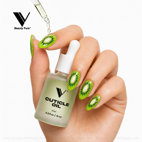 Hand with kiwi nail art holds V Beauty Pure - Kiwi Cuticle Oil; dropper hovers above this nourishing nail treatment.