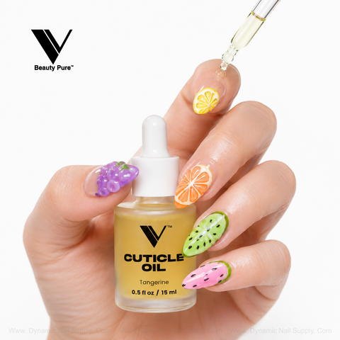 Fruit nail art gets V Beauty Pure Tangerine Cuticle Oil from a dropper onto an orange-slice accent.