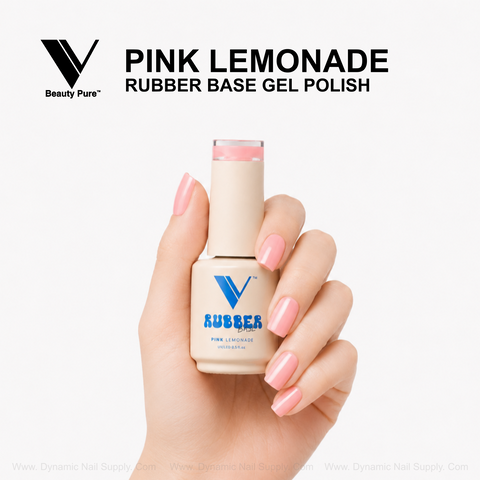 A hand with pink nails holds a V Beauty Pure Pink Lemonade Rubber Base Gel Polish bottle on a white background.