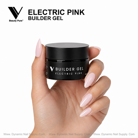 A hand with glossy pink nails holds a black jar of V Beauty Pure Electric Pink Builder Gel by Dynamic Nail Supply.