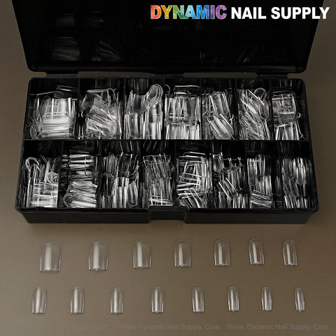 A black box of Natural Square (Short) Soft-Gel Nail Tips sits on a brown surface, tips arranged in neat rows.
