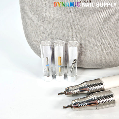 Three ONAIL Precision Portable AI Nail Drills and two metallic handles are displayed in front of a gray bag.