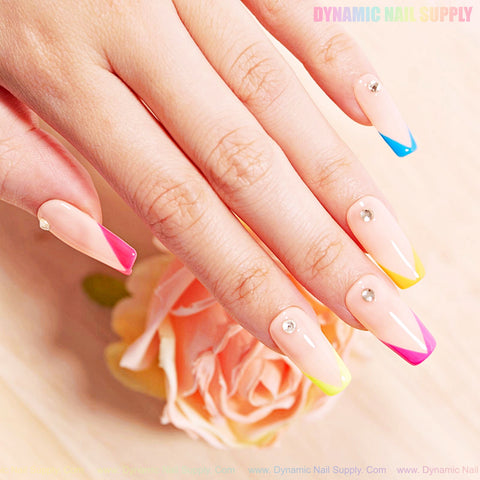 A hand with long coffin nails in BIAB Rubber Base Nude Gel Polish, colorful French tips, and sparkling rhinestones.