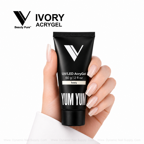 Hand with pale manicured nails holds Ivory - V Beauty Pure AcryGel tube (UV/LED, 60g) on a white background.