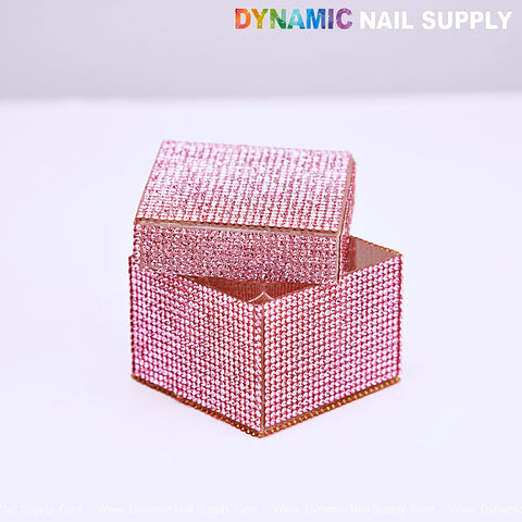 A Rhinestone Square Pink Dappen Dish with Lid by DYNAMIC NAIL SUPPLY sits on a white surface, lid open.