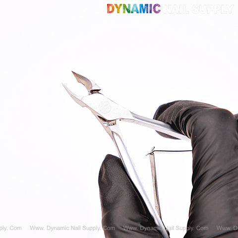A gloved hand holds the NT1219 - G04 5mm Professional Stainless Steel Cuticle Nippers against a white background.