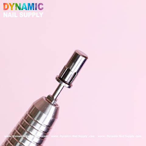 Close-up of a high-quality Easy-Off Sanding Band Mandrel attached to a metallic drill handle against a pink background. The drill handle boasts a ridged grip while the cylindrical mandrel ensures precision. Dynamic Nail Supply shines in colorful text at the top left corner, with repeated website URL at the bottom.