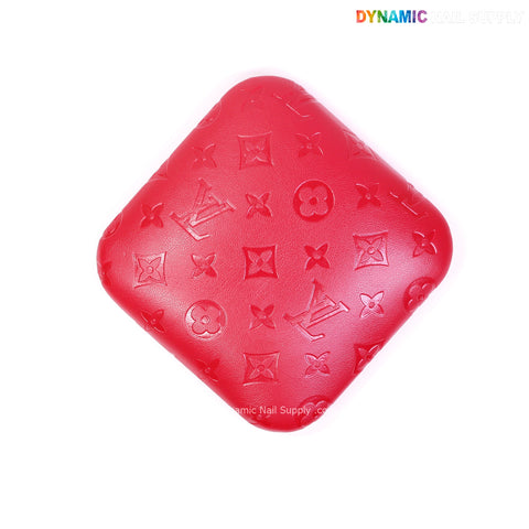 A red LV Engrave elbow pad for nail techs, soft PU leather, supportive, square-shaped, on a white background.