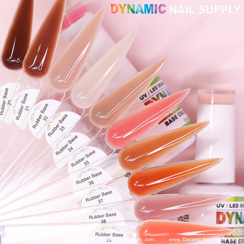 A selection of nail polish samples on elongated, clear swatches showcases shades ranging from light pinks and nudes to vibrant reds and browns. Each swatch is labeled with the BIAB (Builder Gel in a Bottle) Rubber Base gel from numbers 30 to 39, set against a pink background with the Dynamic Nail Supply brand partially visible at the top.