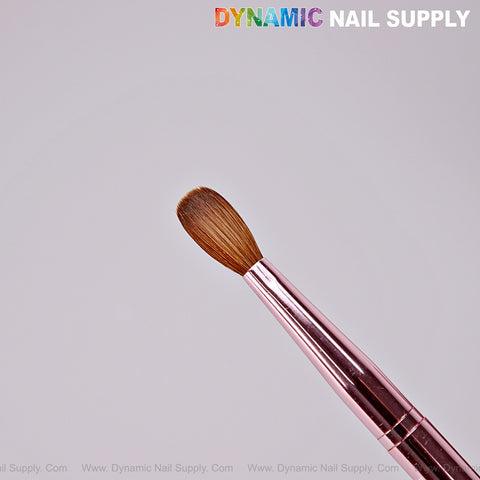 Dynamic Metallic Pink 100% Kolinsky Nail Brush with brown bristles shown on light background with Dynamic Nail Supply text.