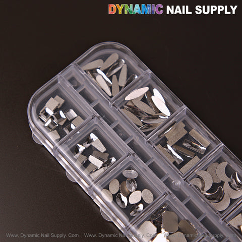 The Silver 3 Mixed 12 Nail Art Gems set holds raindrop, square, heart, and moon rhinestone shapes for crystal nail designs.