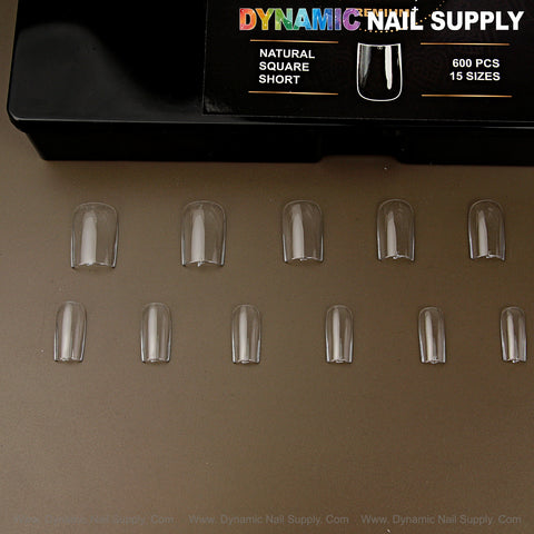 Twelve Natural Square (Short) Soft-Gel nail tips are shown below a black Dynamic Nail Supply box.