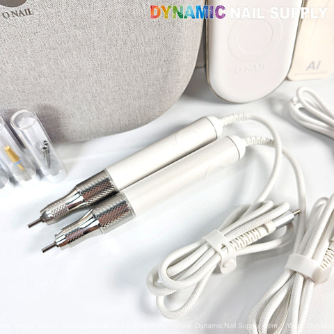 Two ONAIL Precision Portable AI Nail Drills with cords, nail accessories, and a Dynamic Nail Supply case shown.