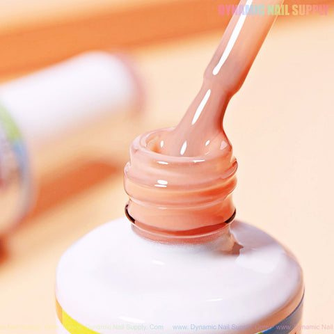 A close-up of the (BIAB) Rubber Base Nude Builder Gel Polish (01-12) brush above an open white bottle.