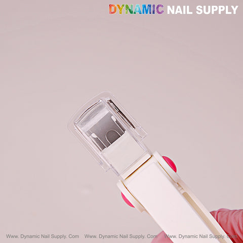A white Nail Tip Cutter with measure spacers is held up; DYNAMIC NAIL SUPPLY logo appears at top right.