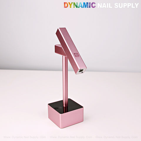 The 2 in 1 Mini UV/LED Flash Cure Lamp with a pink, angled head sits on a white surface.