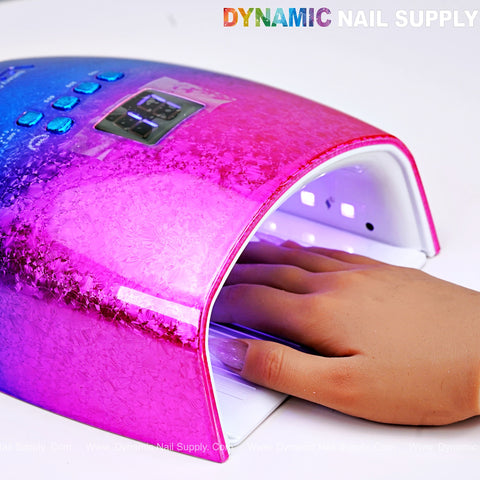 A hand dries gel nails under the [Rainbow] Cordless LED/UV Lamp—48W Rechargeable Gel Nail Dryer by DYNAMIC NAIL SUPPLY.