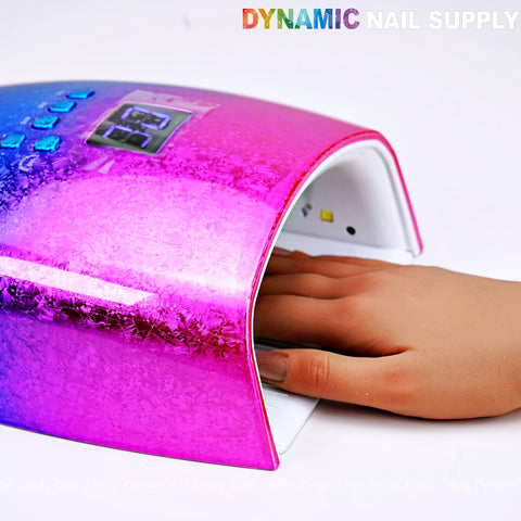 A hand in the [Rainbow] Cordless LED/UV Lamp 48W Gel Nail Dryer by DYNAMIC NAIL SUPPLY, curing nails.