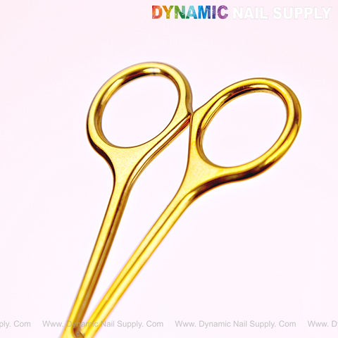 NT1245 - Gold Premium Curved Tip Cuticle Scissors are displayed on a light pink background with DYNAMIC NAIL SUPPLY text above.