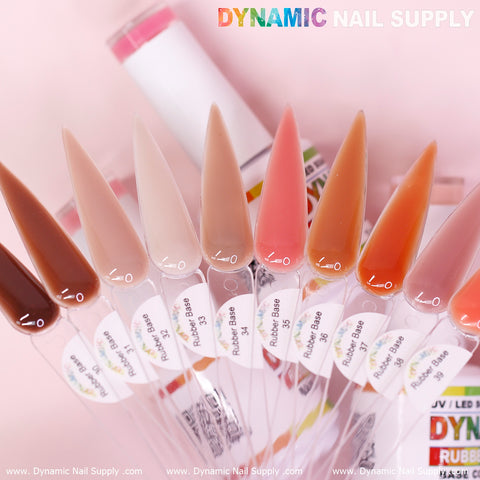 A display featuring nine nails beautifully presents various shades from the Dynamic Nail Supply's (BIAB) Rubber Base gel collection, numbered 30 to 39. The shades transition from light pink to deep brown, with each nail clearly labeled by its respective shade number. In the background, a partially visible bottle prominently displays the brand's name at the top.