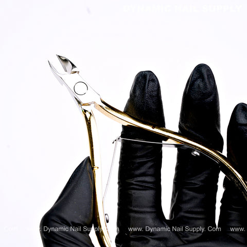 A hand in black gloves holds the D501 Ergonomic Carbon Steel Cuticle Nippers against a white background.