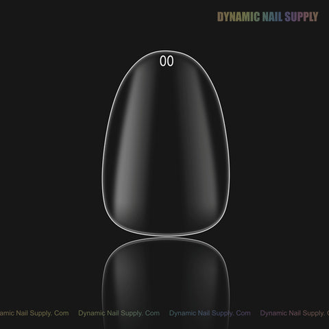A single Natural Round (Short) Full Cover Soft-Gel Nail Tip (00) is centered on a black background with a faint watermark.