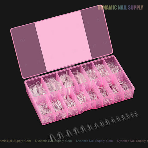 A pink box holds Natural Round (Short) Full Cover Soft-Gel Nail Tips, with black tips shown below on a black surface.