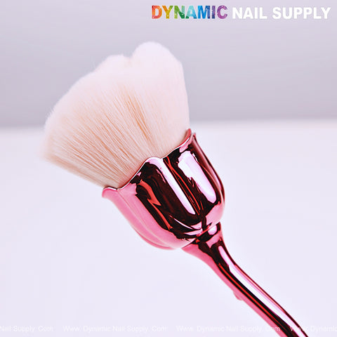 Close-up of the [Metal Pink] Rose Nail Dust Cleaner Brush for Cleaning Dust Dip Powder, DYNAMIC NAIL SUPPLY above.