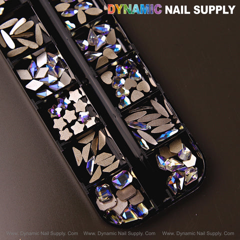A black plastic case holds Crystal Blue AB 6 nail rhinestone gems—12 mixed shapes for nail art on a dark background.