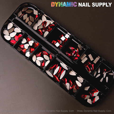 Black box of Ruby Red 3 Nail Art Rhinestone Gems, 12 mixed shapes in red and silver; Dynamic Nail Supply on top.