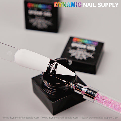 A nail brush applies No-wipe Ready for Chrome Spider Gel to a white tip near Dynamic Nail Supply gel containers.