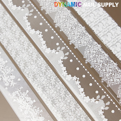 White Mixed Design Nail Foil 4: Four white lace nail foils on brown, DYNAMIC NAIL SUPPLY logo at top right.