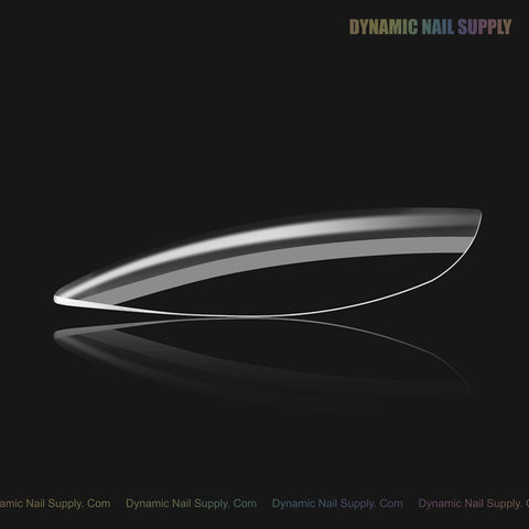 One clear, curved Natural Almond (Medium) Soft-Gel Tip on black, with Dynamic Nail Supply text in the top right.