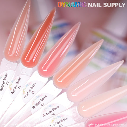 A close-up of a nail polish sample fan displaying gradient shades ranging from pink to nude, with each swatch labeled Rubber Base Gel 40 to 48. The background is softly blurred, and "Dynamic Nail Supply" appears in colorful and gray fonts in the top-right corner.